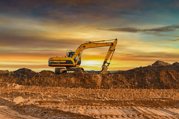 istock Excavator on sunset. Open-pit mining. Backhoe dig ground in quarry. 2213174957