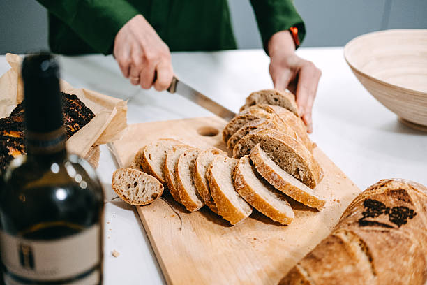 istock Slicing Artisan Sourdough Bread on Wooden Board 2213175042