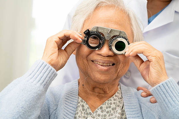 istock Optometrist checking Asian elderly woman ophthalmic vision eye test and using optical trial frame. 2213177356