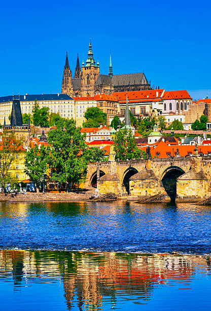 istock Prague Castle and Charles Bridge Reflected in Vltava River. Iconic Historic Architecture with Mirror-like Water View, Ideal for Travel and Tourism Concepts. Vertical Stock Photography. 2213177577