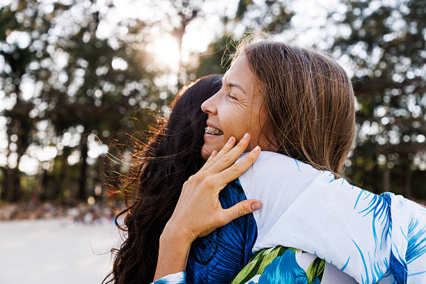 istock Two women embracing outdoors, expressing joy and connection during a sunny day 2213178056