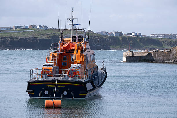 Portrush, Northern Ireland - May 2nd, 2025: Portrush RNLI Lifeboat moored in harbour on bright sunny spring day.