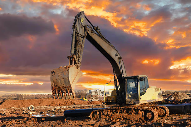 istock Excavator dig ground on construction site. Laying external sewer pipes in trench. Sewage drainage building. 2213179213