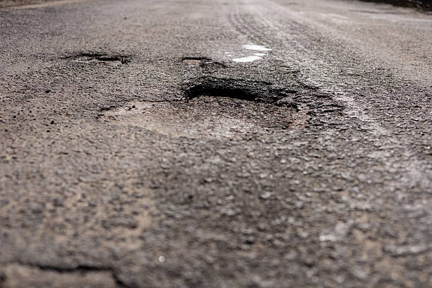 istock A significant crack in the asphalt on a highway poses a danger for drivers, necessitating immediate maintenance and repair efforts 2213181269