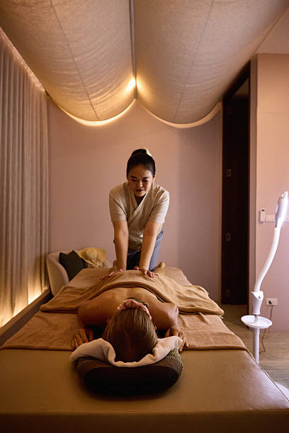 istock Professional massage therapist providing relaxation therapy for a client on a spa table 2213181753