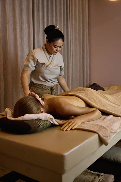 istock Professional massage therapist performing a relaxing body massage in a spa setting 2213181756