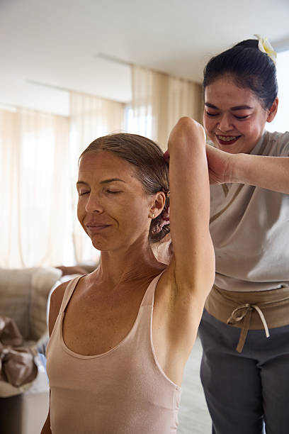 istock Massage therapist helping a woman relax during a therapeutic spa session 2213183016