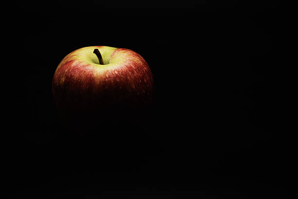 istock An apple fading in black. 2213183221