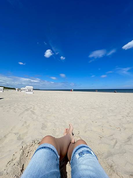 istock woman legs with a view on the beach 2213183512