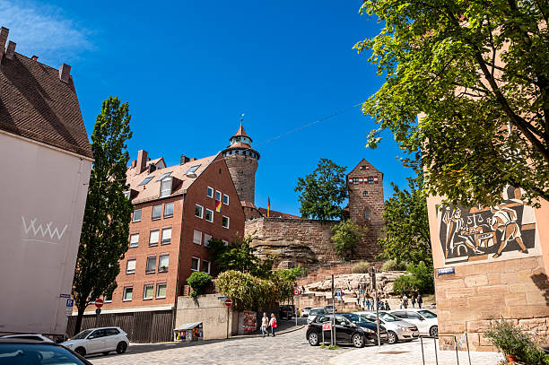 Nuremberg, Germany, August 1, 2023. Pleasant view from the historic center towards the castle. Beautiful summer day, people walk along the road to go up to the castle.