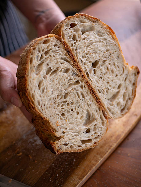 istock Baker's Hand Presenting Homemade Sourdough. 2213186240
