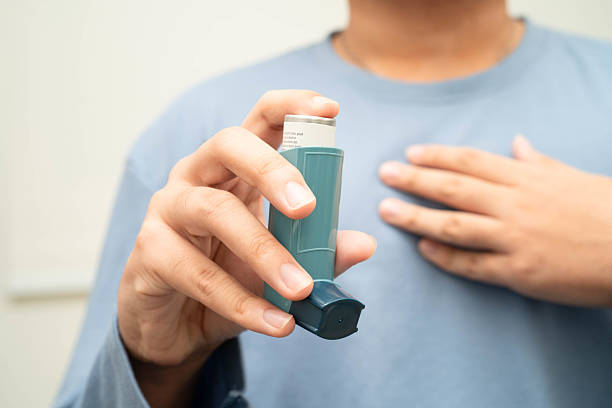 istock Asthma and chronic obstructive pulmonary disease COPD, Asian young man using metered dose inhaler MDI. 2213186646