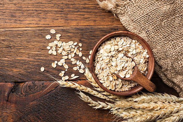 istock Rolled oats, oat flakes in wooden bowl 2213187802