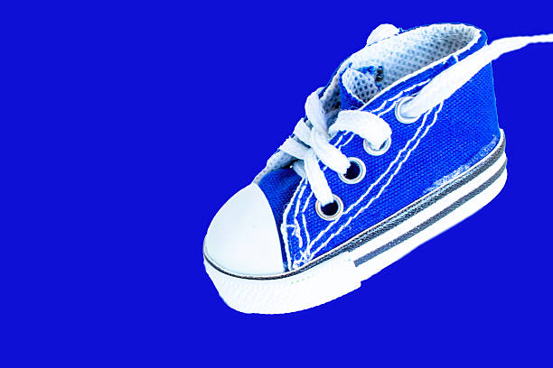 Bright Blue Miniature Sneaker With White Laces on a Plain Background Showcasing Detail and Craftsmanship for Young Fashion Enthusiasts.