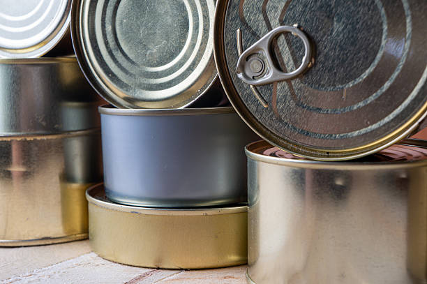 Round tin cans with food on the surface