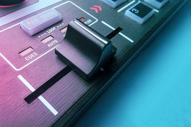 Close-up view of a DJ mixer volume fader with smooth lighting