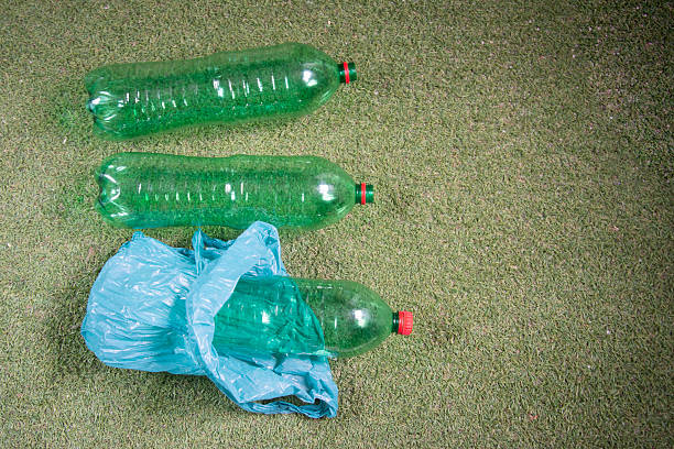 istock green plastic bottle on top of grass 2213191148