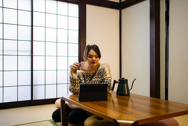 istock Woman sitting at table, using laptop 2213191430