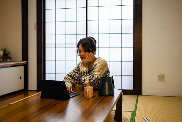 istock Woman sitting at table, using laptop 2213191454