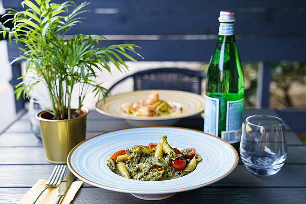 istock Penne pasta with pesto sauce and cherry tomatoes 2213192686