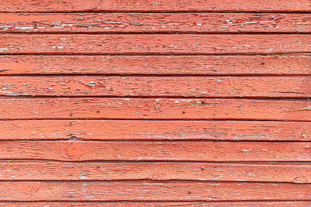 istock Weathered red wooden wall with peeling paint and horizontal planks 2213193010