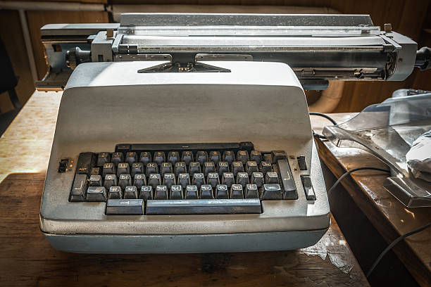 istock Old typewriter on an old wooden office desk 2213194381
