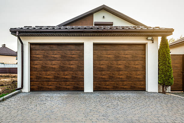 istock Luxury house with double garage door. Transportation theme 2213195112