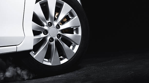 Luxury Metallic Car Wheel, Close-up of a alloy wheel with tire of car on black background.