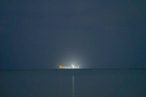 Browns Bay sea at night with a ship moored in the distance