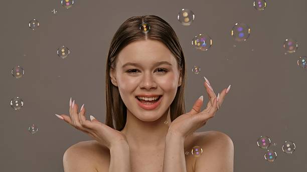 istock Woman Enjoying Colorful Bubbles Floating Around Her Joyfully 2213199422