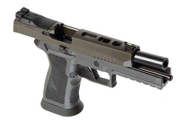istock Khaki-colored handgun with a textured grip, side view, isolated on a white background, modern firearm design, suitable for self-defense or law enforcement use. 2213199600