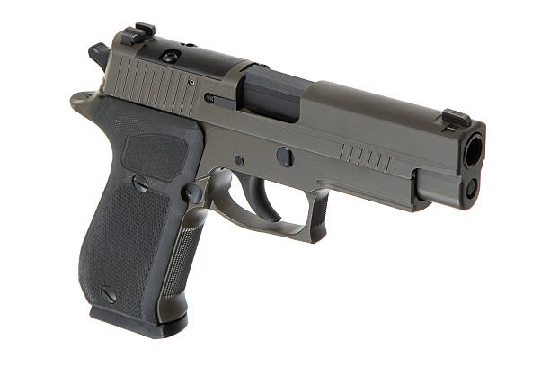 istock Khaki-colored handgun with a textured grip, side view, isolated on a white background, modern firearm design, suitable for self-defense or law enforcement use. 2213199714