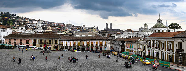 Quito, Ecuador, October 19, 2022: The people walk on the San Francisco Square (Plaza San Francisco) in the Ecuadorian capital under cloudy sky.