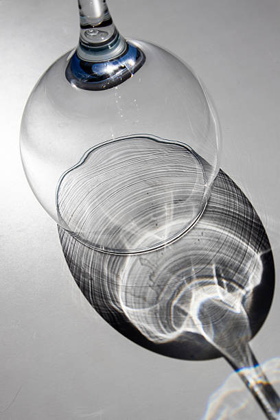 istock Upside down gin glass in sunlight on white surface, Wirral, Merseyside, England, Britain 2213202920