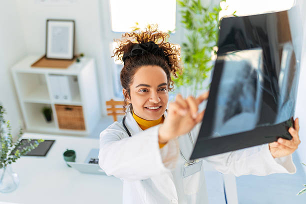 istock Doctor Studying X-Ray for Diagnosis in Modern Office 2213206141