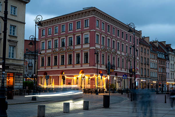 Long exposure of streaking headlights in old town market square at dusk, Warsaw