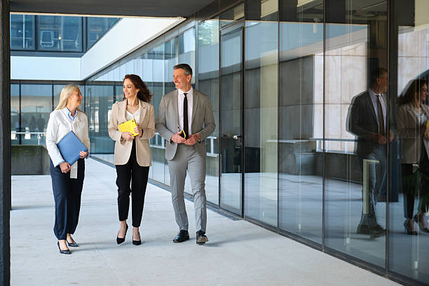 istock Business team walking outside modern office building 2213207490