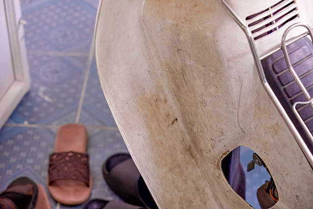 Close-up of a scratched, worn scooter body panel, highlighting years of use and detailed imperfections.
