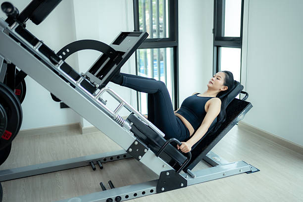 istock Asian woman training on leg press machine at gym. 2213207998