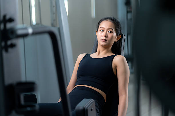 istock Asian woman training on leg press machine at gym. 2213208101