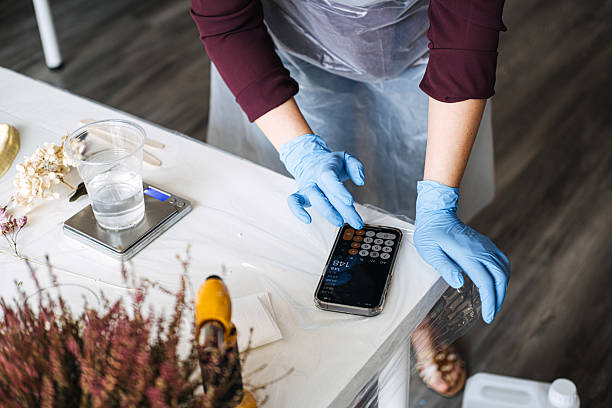 istock Crafting process with precise measurements, artisan calculating resin mixture. DIY projects, handmade decor, creative hobbies, sustainable crafts, artisan work, floral preservation. 2213211672