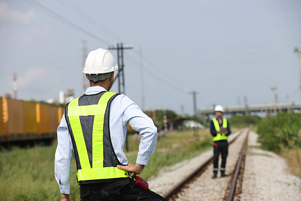 istock Two male logistics engineers are working at the Container railway yard. Cargo port storage for transportation and trading in the rail shipping yard 2213212595