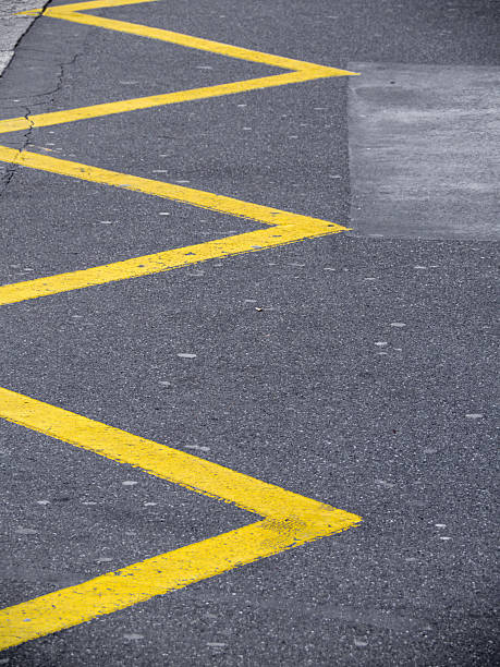 istock Yellow Zigzag Road Markings on Asphalt 2213215151