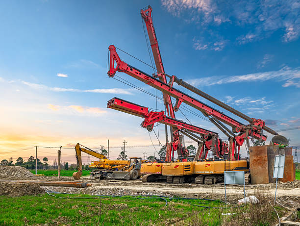 istock Heavy drilling rig machine and excavator at outdoor construction site under blue sky. 2213217784
