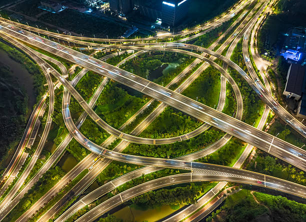 istock Aerial view of illuminated circular highway interchange roundabout with light at night. 2213218792