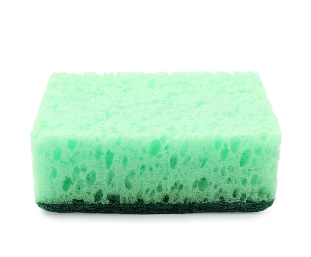 istock One green sponge isolated on white. Cleaning tool 2213221207