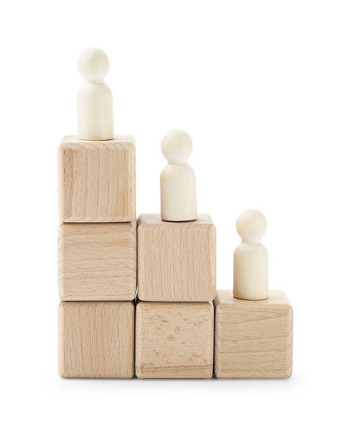 istock Human figures on wooden blocks against white background. Competition concept 2213221951