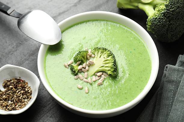 istock Delicious broccoli cream soup served on black table, closeup 2213222942