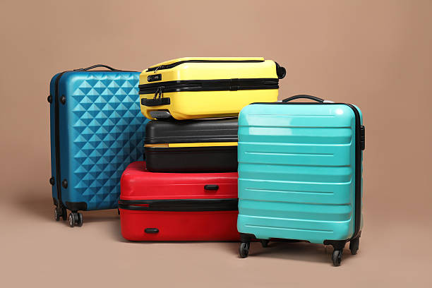 istock Many closed colorful suitcases on beige background 2213223284