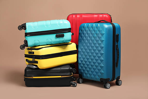 istock Many closed colorful suitcases on beige background 2213223307